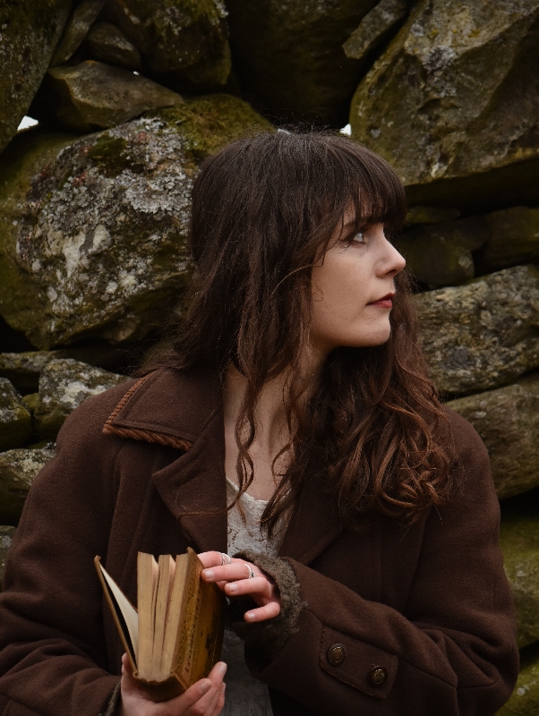 Portrait of finalist reading a book outdoors