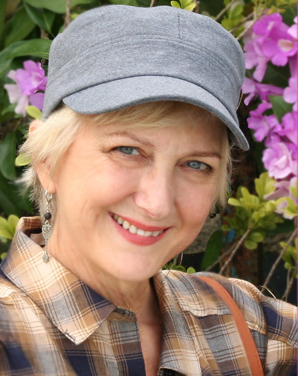 Middle aged blonde woman in a gray cap.
