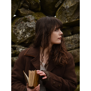 Portrait of finalist reading a book outdoors