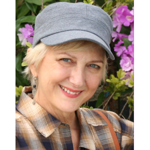 Middle aged blonde woman in a gray cap.