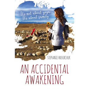 The cover of the book An Accidental Awakening: a woman holds a sunflower near a medicine wheel with the Rocky Mountains in the distance.
