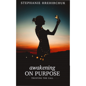 The cover of the book Awakening on Purpose: the outline of a woman at sunset. She holds a bulb filled with fairy lights.